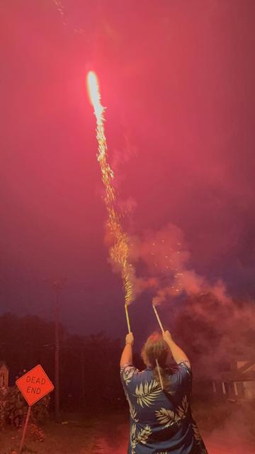 Man in Hawaiian shirt shooting Roman Candle