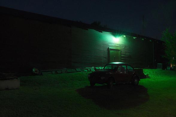 A Volkswagen Beetle under green light.