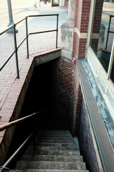 Staircase heading into blackness.
