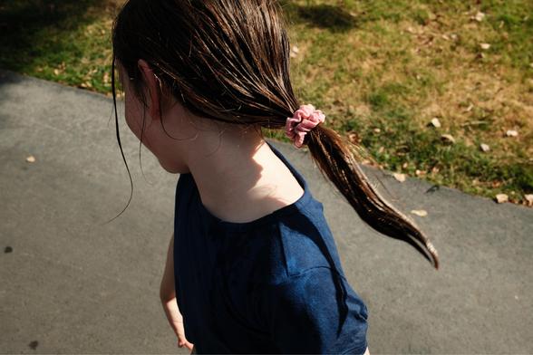 A girl flinging her pony tail.