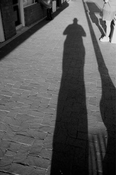 My silhouette on a brick sidewalk.