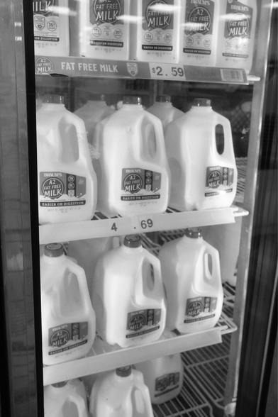 Milk in a grocery cooler.