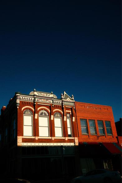Old brick buildings under a blue sky.