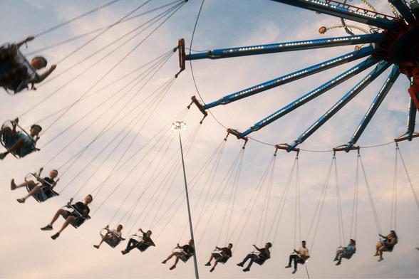 People on swings at the state fair.
