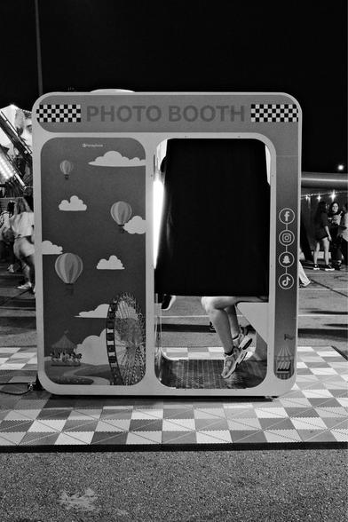 Feet dangling under the curtain in a Photo Booth.