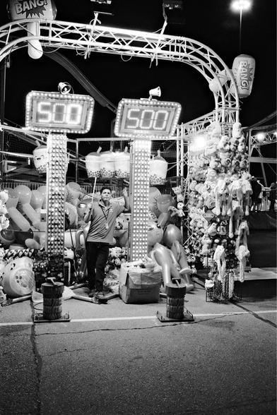 Carnival worker looking for customers.