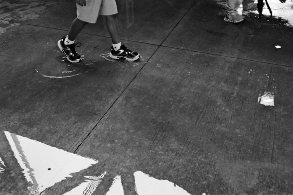 Feet walking through a puddle